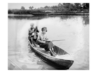 man-and-woman-in-a-canoe-the-woman-holds-a-gun-1921.jpg