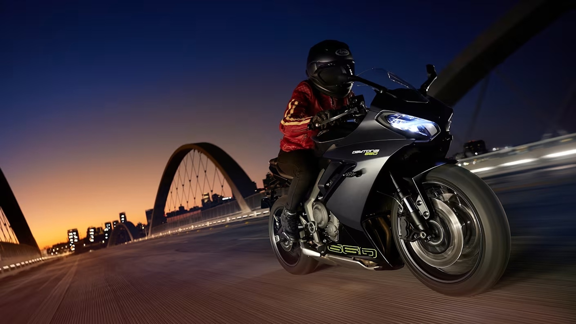 A close-up of a rider on a Triumph sport bike.