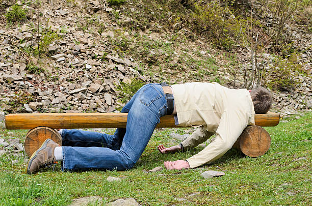 young-man-deeply-sleeping-on-a-bench-outdoors-picture-id187210301