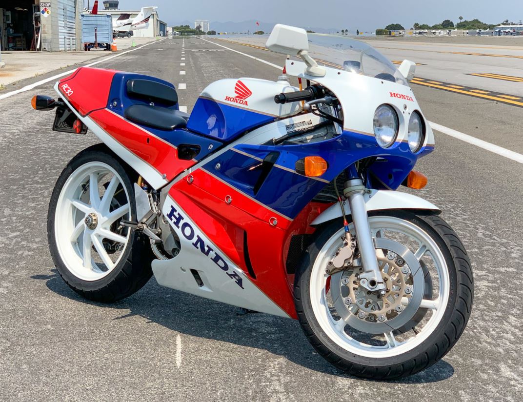 A 1987 Honda VFR750R motorcycle at a sunny racetrack