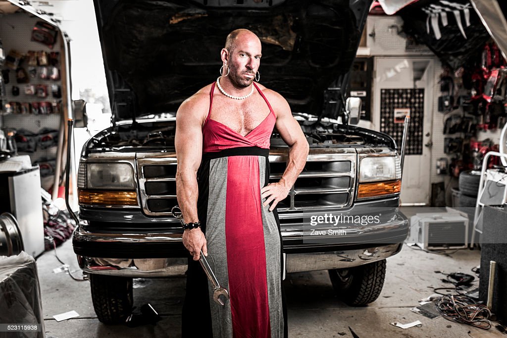 man-in-a-dress-repairing-a-truck-picture-id523115938