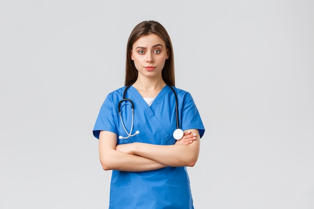 healthcare-workers-prevent-virus-insurance-medicine-concept-skeptical-female-nurse-doctor-blue-scrubs-cross-arms-chest-stare-with-impatients-smirk-disapproval_1258-57348.jpg