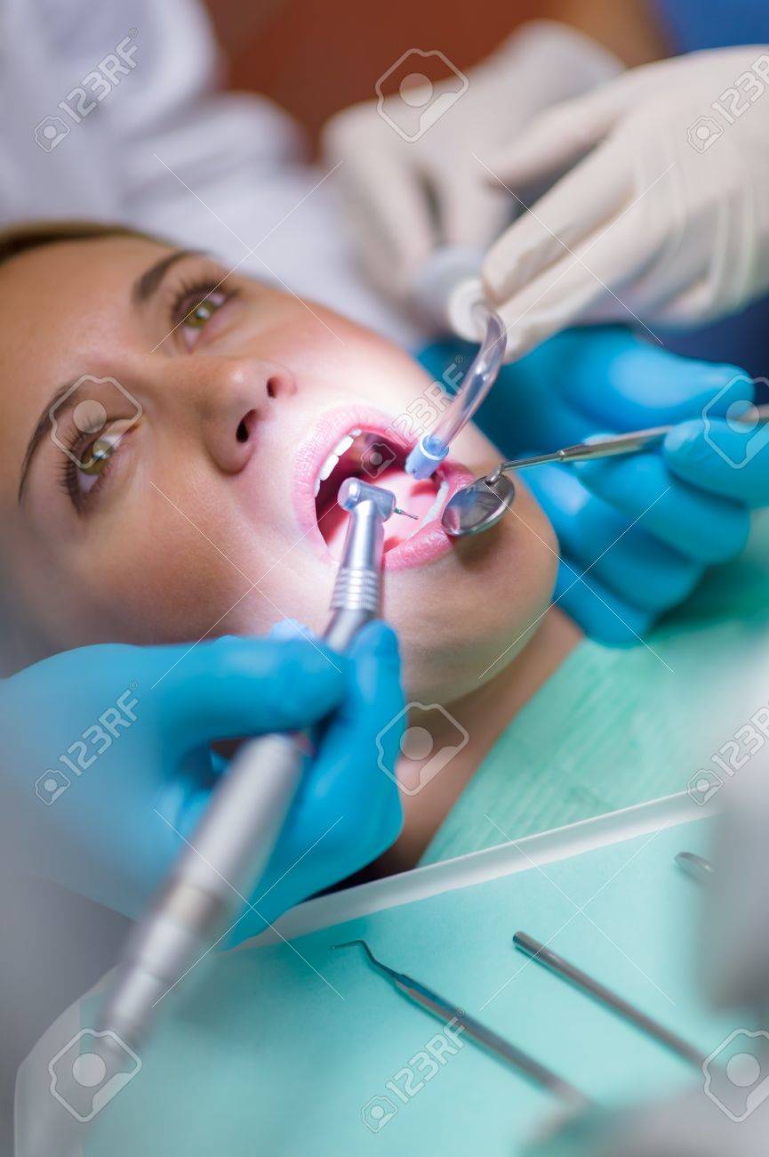 15412668-Close-up-of-open-mouth-at-dental-surgery-with-tools-Stock-Photo.jpg
