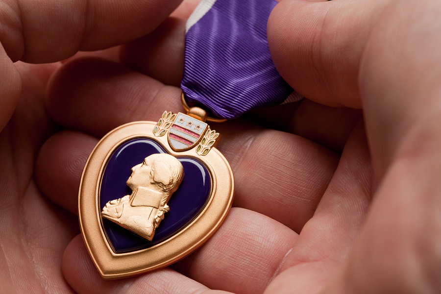 bigstock-Man-Holding-Purple-Heart-War-M-5078823.jpg