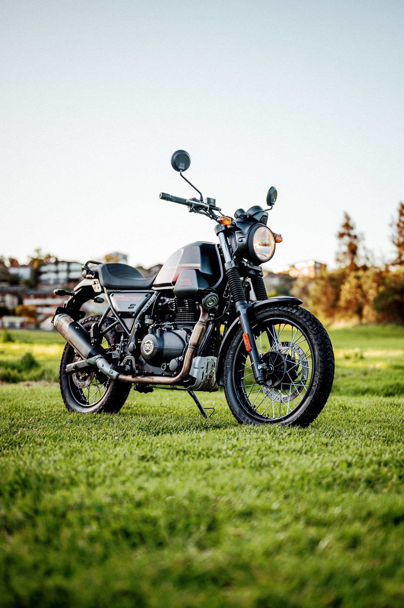 A 2022 Royal Enfield Scram 411 motorcycle in a park at dusk