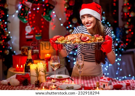 stock-photo-smiling-woman-with-turkey-garnished-with-potato-and-garnet-dressed-with-christmas-hat-on-festive-232918294.jpg