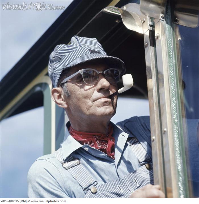 close-up_of_a_railroad_engineer_smoking_a_pipe_on_2029-460525.jpg