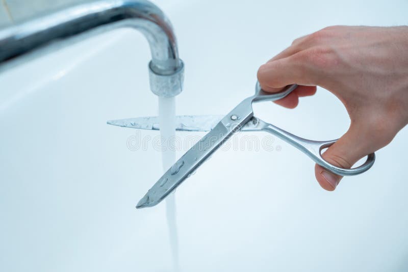 stop-wasting-pure-water-hand-scissors-cut-stream-faucet-home-environmental-problem-problems-169354999.jpg