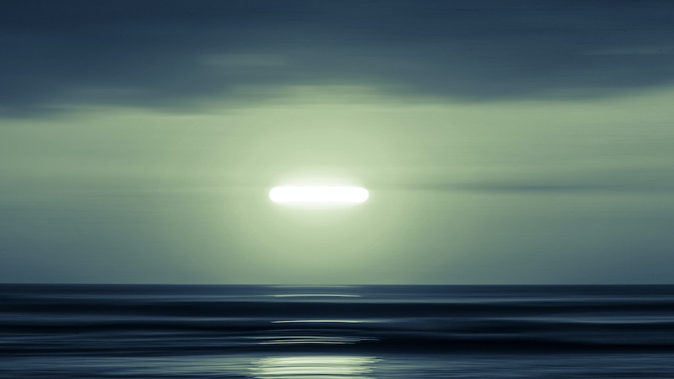 An abstract image of the moon over the ocean in South America.