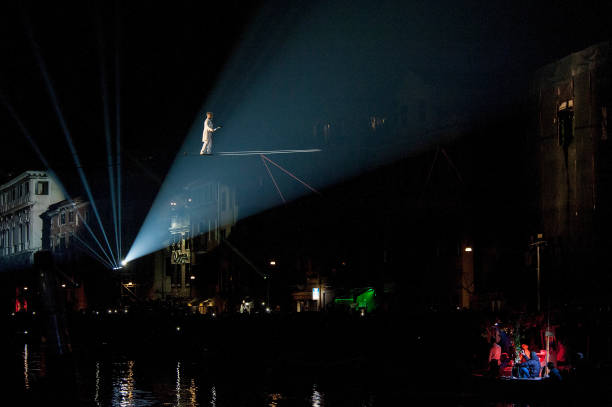 tightrope-walker-performs-along-the-canaregio-canal-during-the-of-picture-id911092364