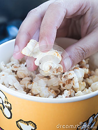 hand-picking-popcorn-yellow-bucket-49608531.jpg