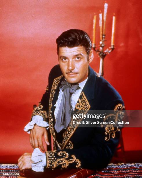 guy-williams-us-actor-wearing-a-mariachi-costume-in-a-studio-portrait-against-a-red-background.jpg