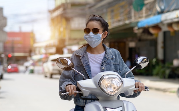 woman-riding-motorcycle-wearing-mask-city_35534-510.jpg