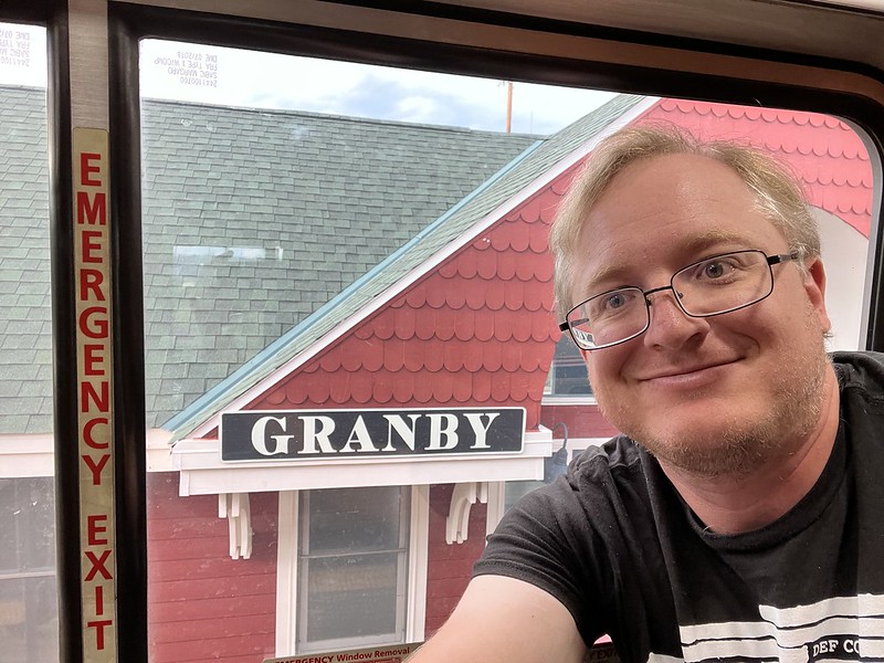 I'm smiling in front of a red building labeled 'GRANBY'