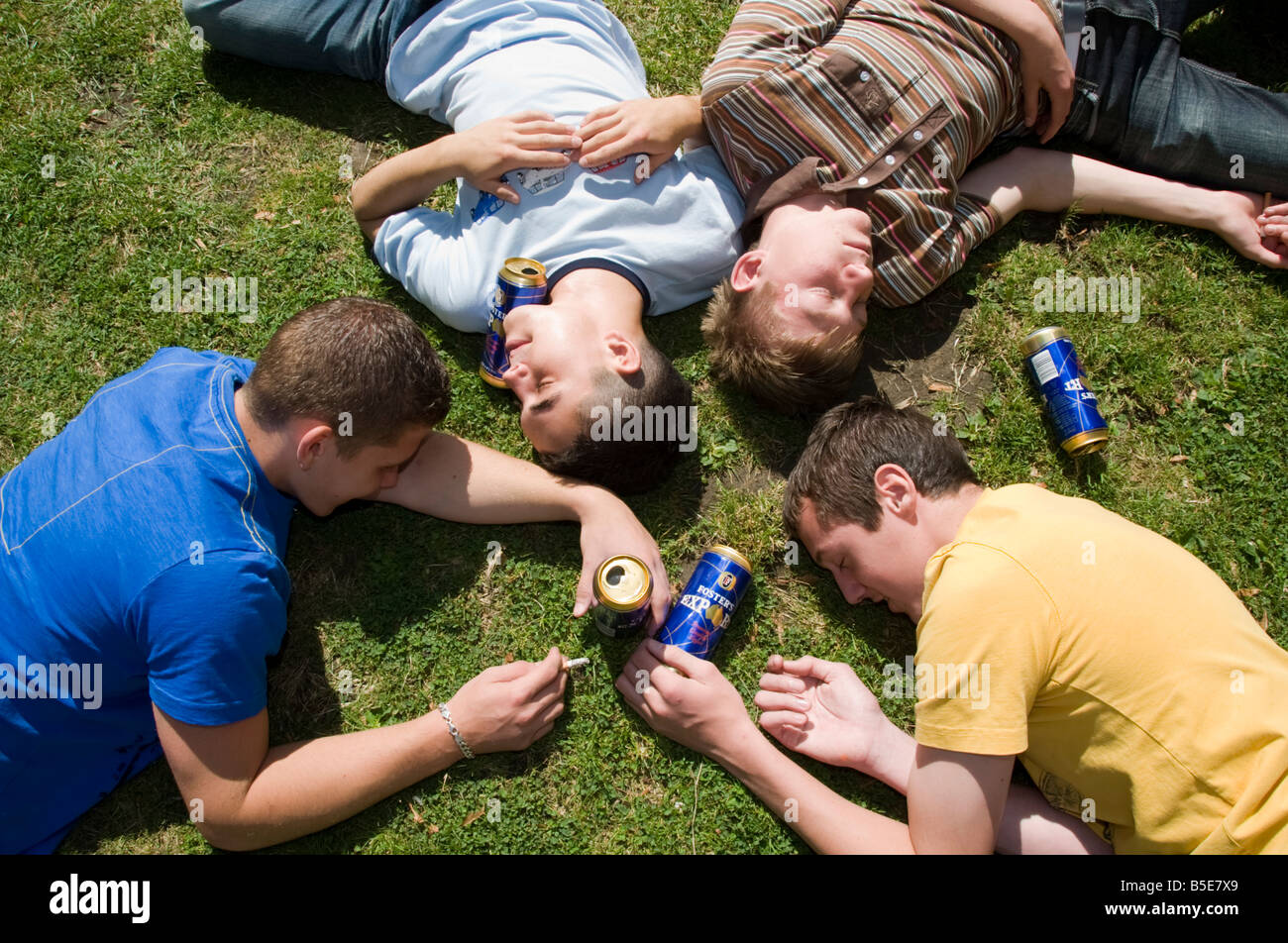 group-of-teenage-boys-who-have-passed-out-on-the-ground-surrounded-B5E7X9.jpg