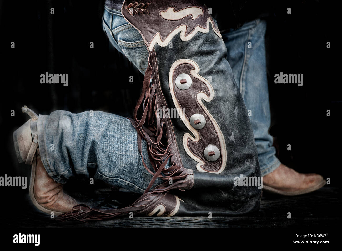 rodeo-cowboy-kneeling-on-one-knee-KD6W61.jpg