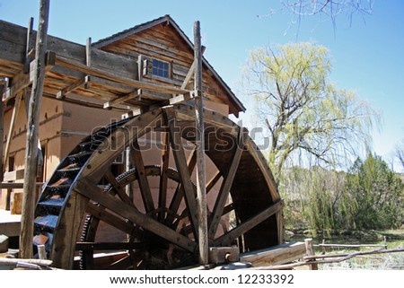 stock-photo-a-old-but-fully-working-water-driven-mill-with-a-rather-large-wooden-waterwheel-located-on-the-12233392.jpg