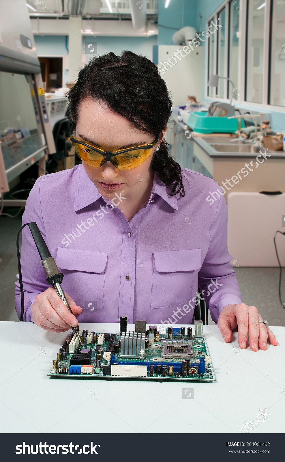 stock-photo-beautiful-woman-repair-soldering-a-printed-circuit-board-204001492.jpg