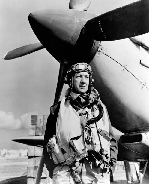 standing-in-front-of-a-mkix-spitfire-actor-alec-guinness-on-the-set-picture-id830194822