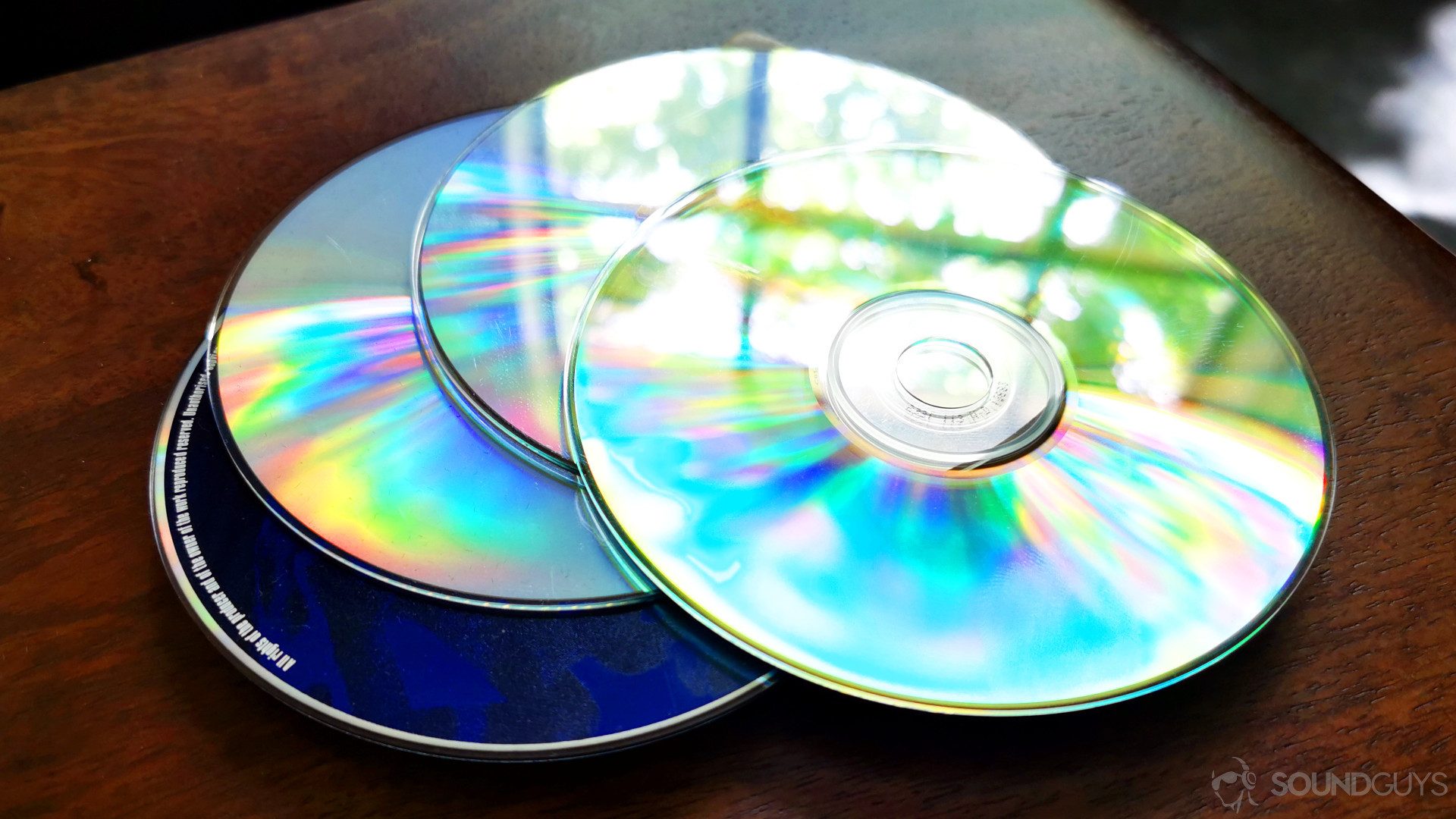 A photo of a stack of CDs on a wooden table - comparing cd quality bit-depth