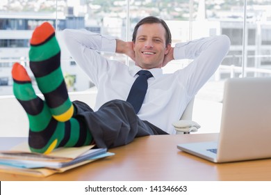 smiling-businessman-relaxing-feet-over-260nw-141346663.jpg