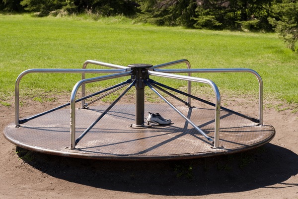 playground-merrygoround-grass-600nw-13344022.jpg