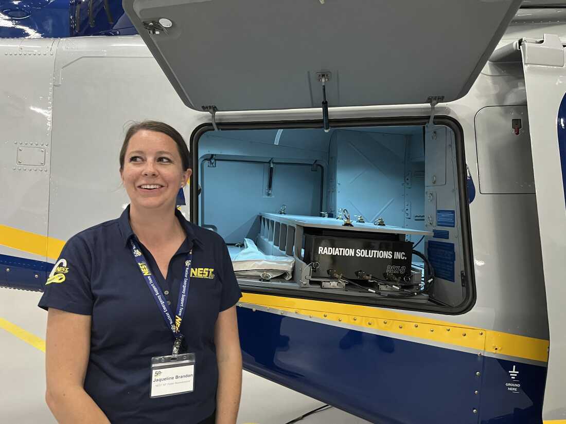 NEST scientist Jaqueline Brandon displays radiation detection equipment inside one of NEST's helicopters. 