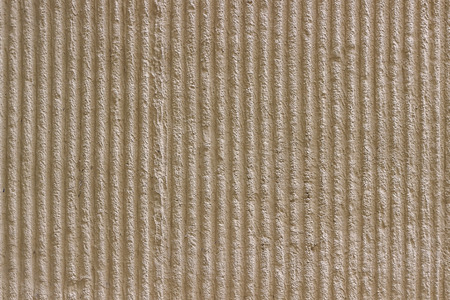 83082185-surface-of-the-wall-with-a-decorative-light-beige-plaster-textured-concrete-wall-with-vertical-lines.jpg
