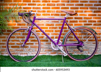 purple-bicycle-front-brick-wall-260nw-605953493.jpg