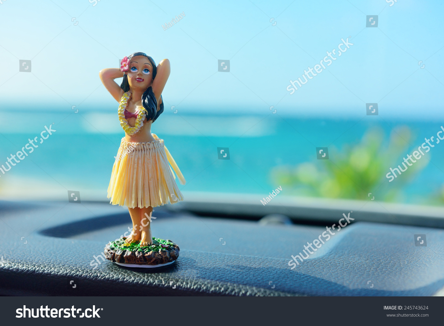 stock-photo-hawaii-road-trip-car-hula-dancer-doll-dancing-on-the-dashboard-in-front-of-the-ocean-tourism-and-245743624.jpg