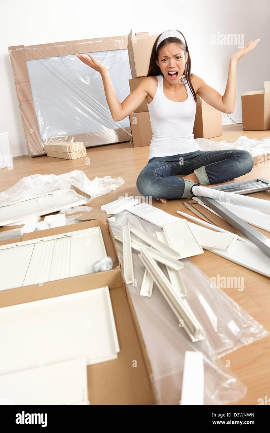 multiracial-asian-caucasian-frustrated-young-woman-moving-in-new-home-D3WNWN.jpg