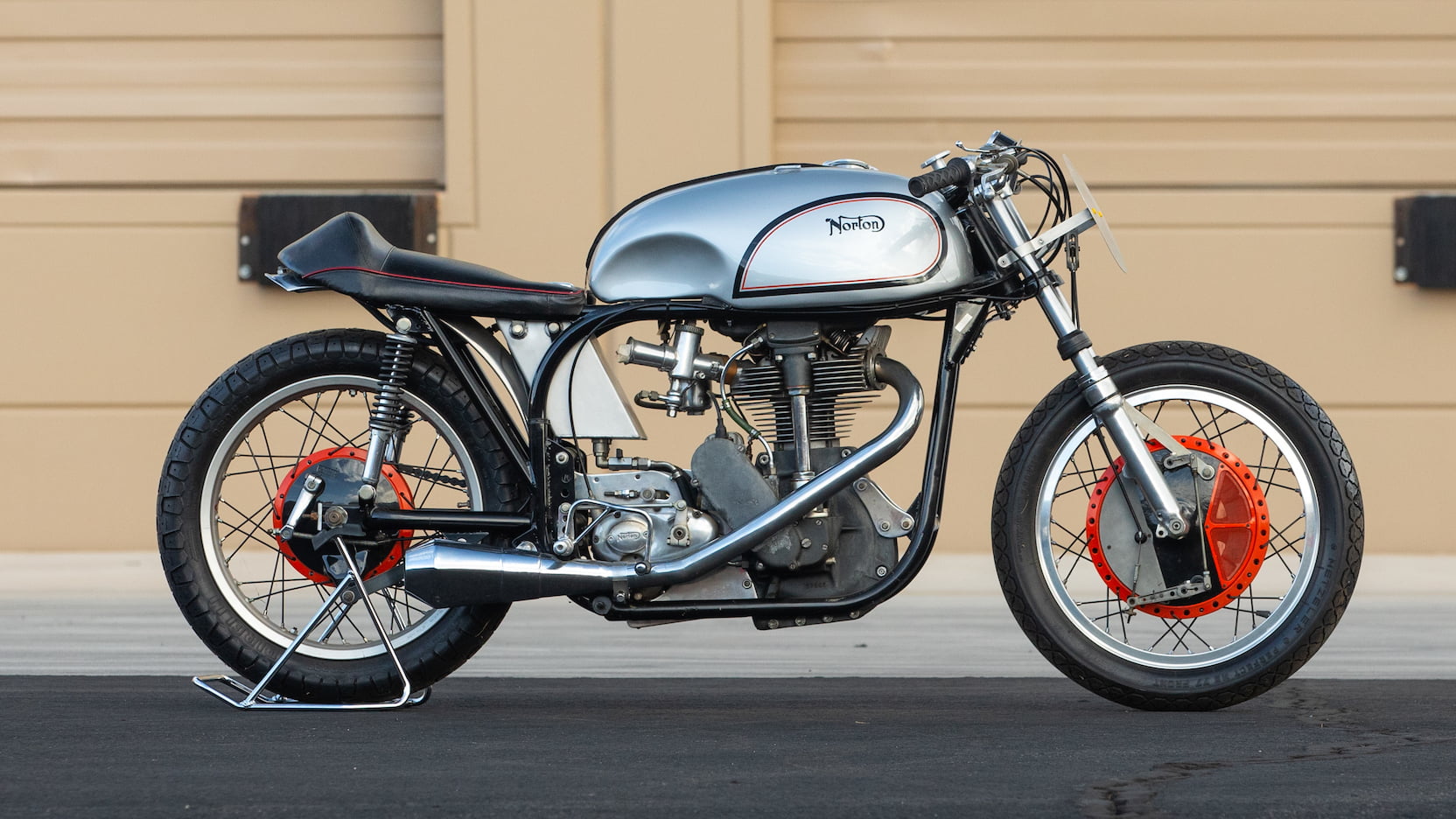 A 1950s Norton Manx motorcycle outdoors in a carpark