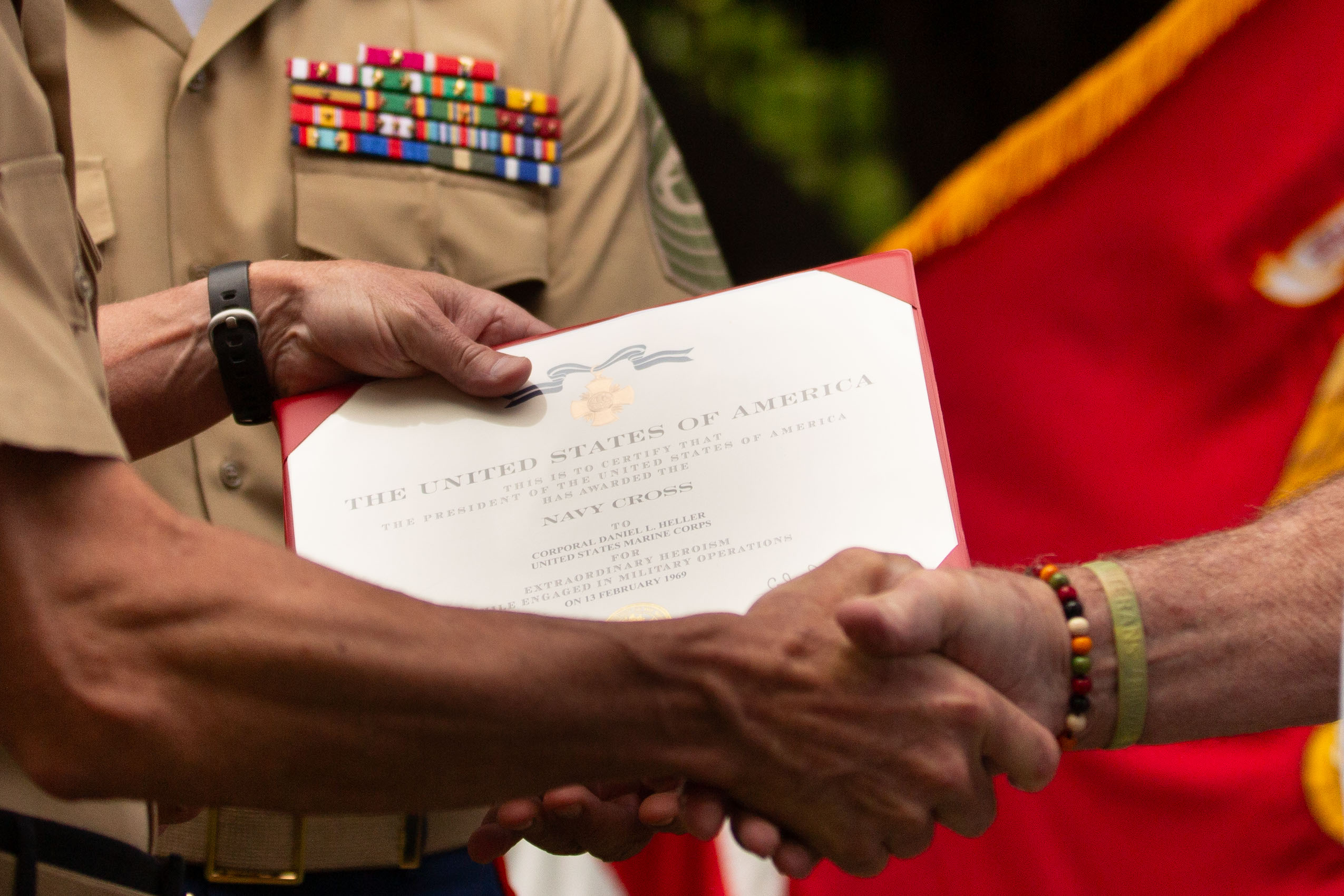 The 39th Commandant of the Marine Corps, Gen. Eric M. Smith, pins Cpl. Daniel L. Heller, a U.S. Marine Corps Vietnam veteran, during his Navy Cross award ceremony at Marine Barracks Washington, Washington D.C., Wednesday, Aug. 28, 2024. The award ceremony was an upgrade to a Navy Achievement Medal (with Valor device) for Cpl. Heller's actions during the Vietnam War on Feb. 13, 1969.