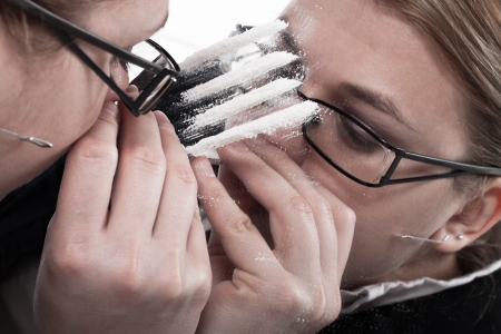 13712212-drug-addicted-businesswoman-reflected-in-mirror-snorting-line-of-cocaine.jpg