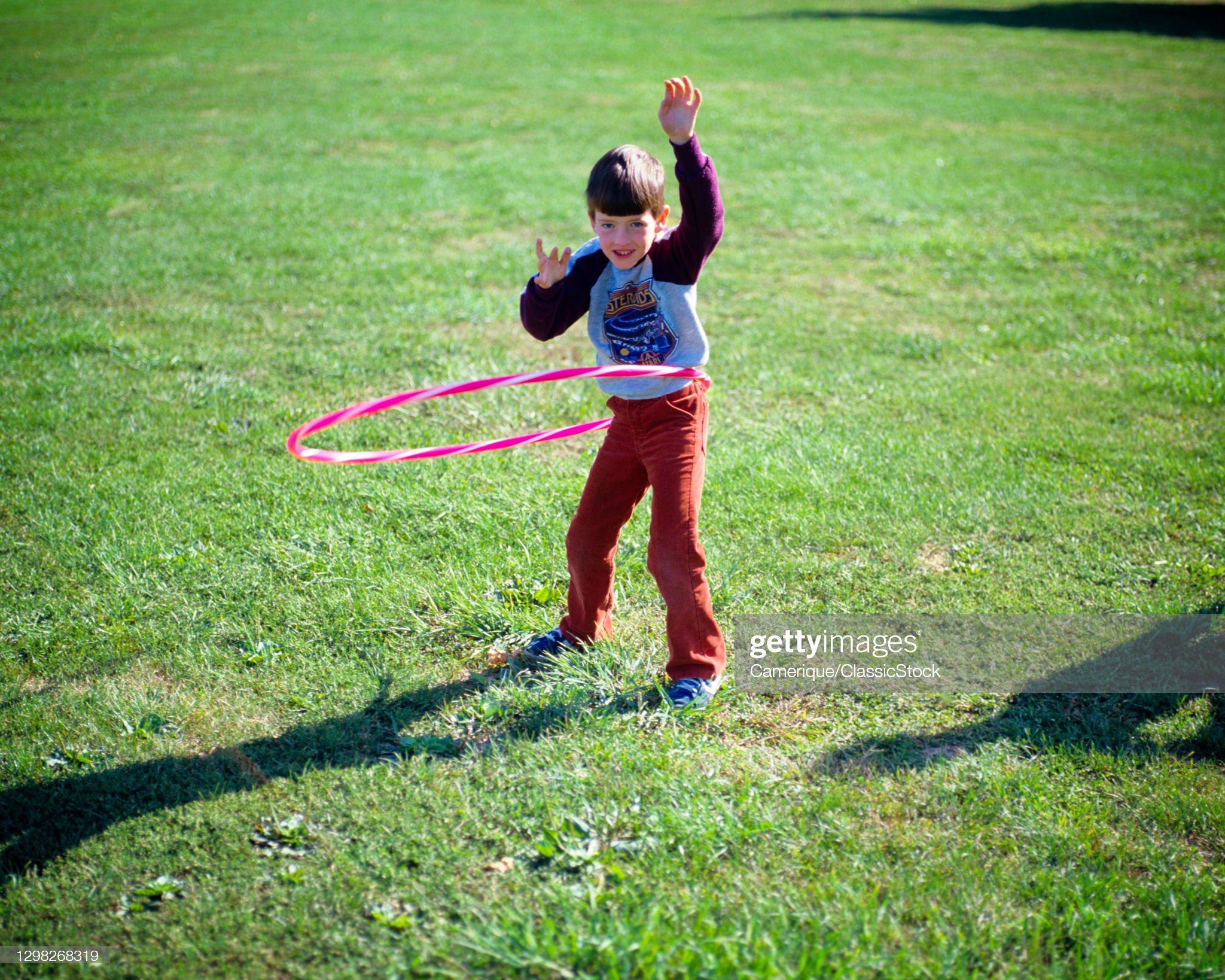 1980s-boy-playing-with-hula-hoop-picture-id1298268319