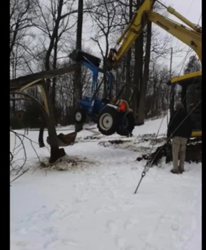 RE Ford tractor hanging from tree. - Yesterday's Tractors