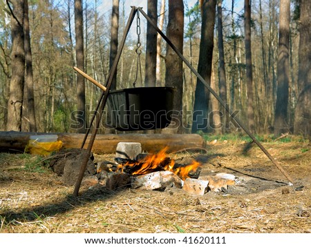 stock-photo-cooking-outdoors-in-cast-iron-cauldron-41620111.jpg