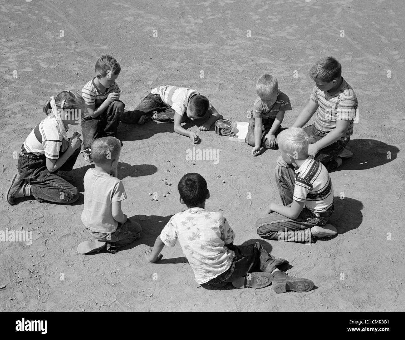 1950s-boys-girls-shooting-marbles-CMR3B1.jpg