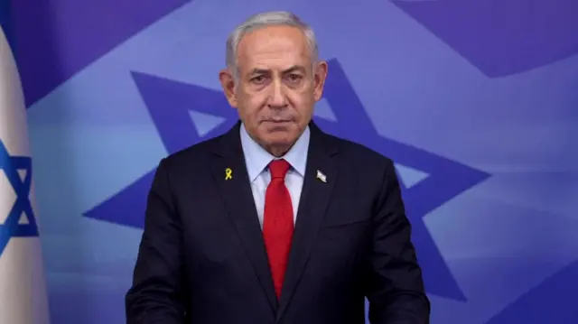 Benjamin Netanyahu in a suit gives a TV address