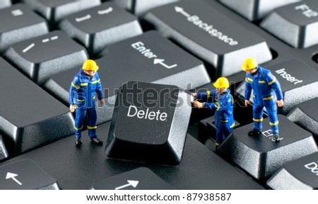 stock-photo-team-of-construction-workers-working-with-delete-button-on-a-computer-keyboard-87938587.jpg