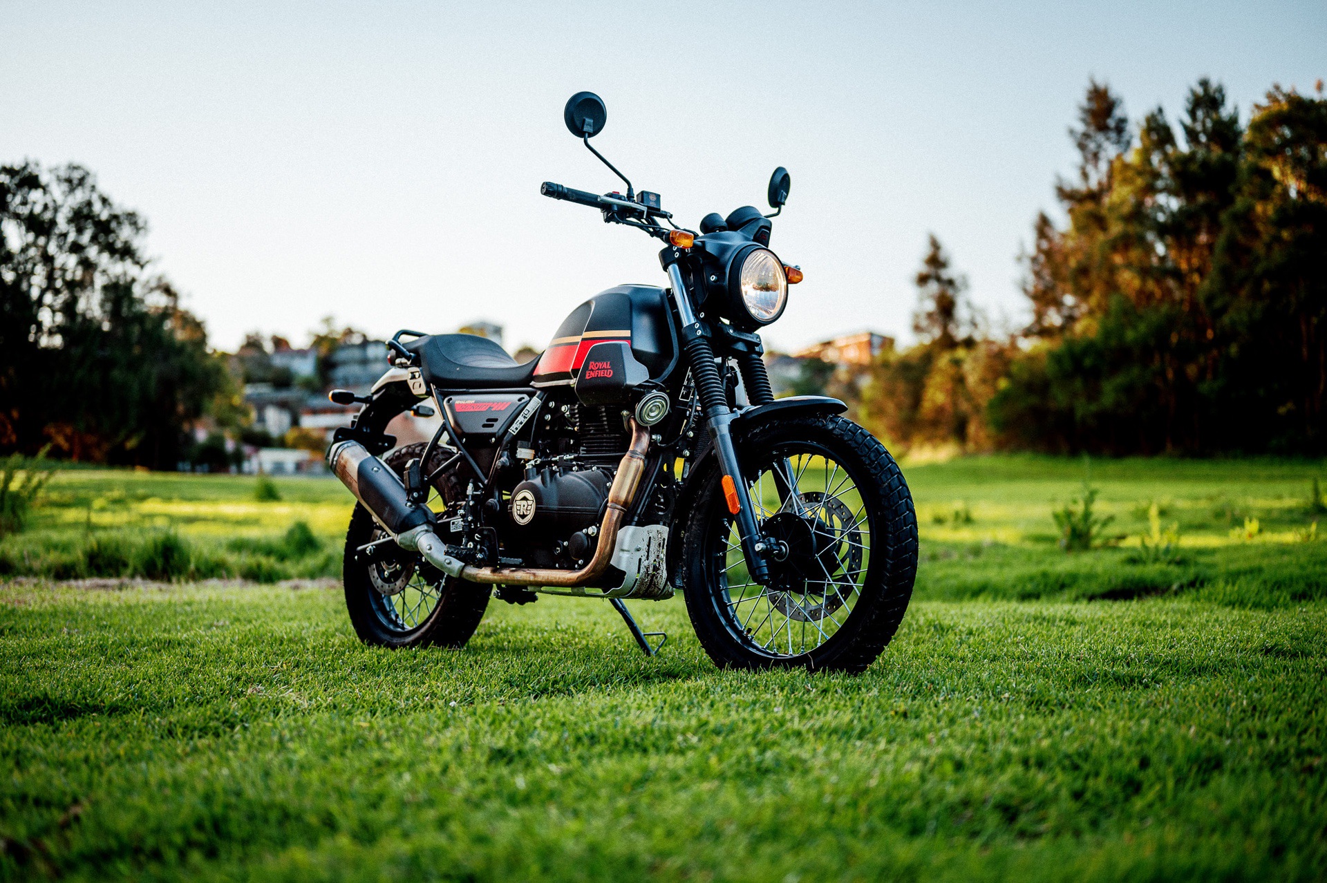 A 2022 Royal Enfield Scram 411 motorcycle in a park at dusk