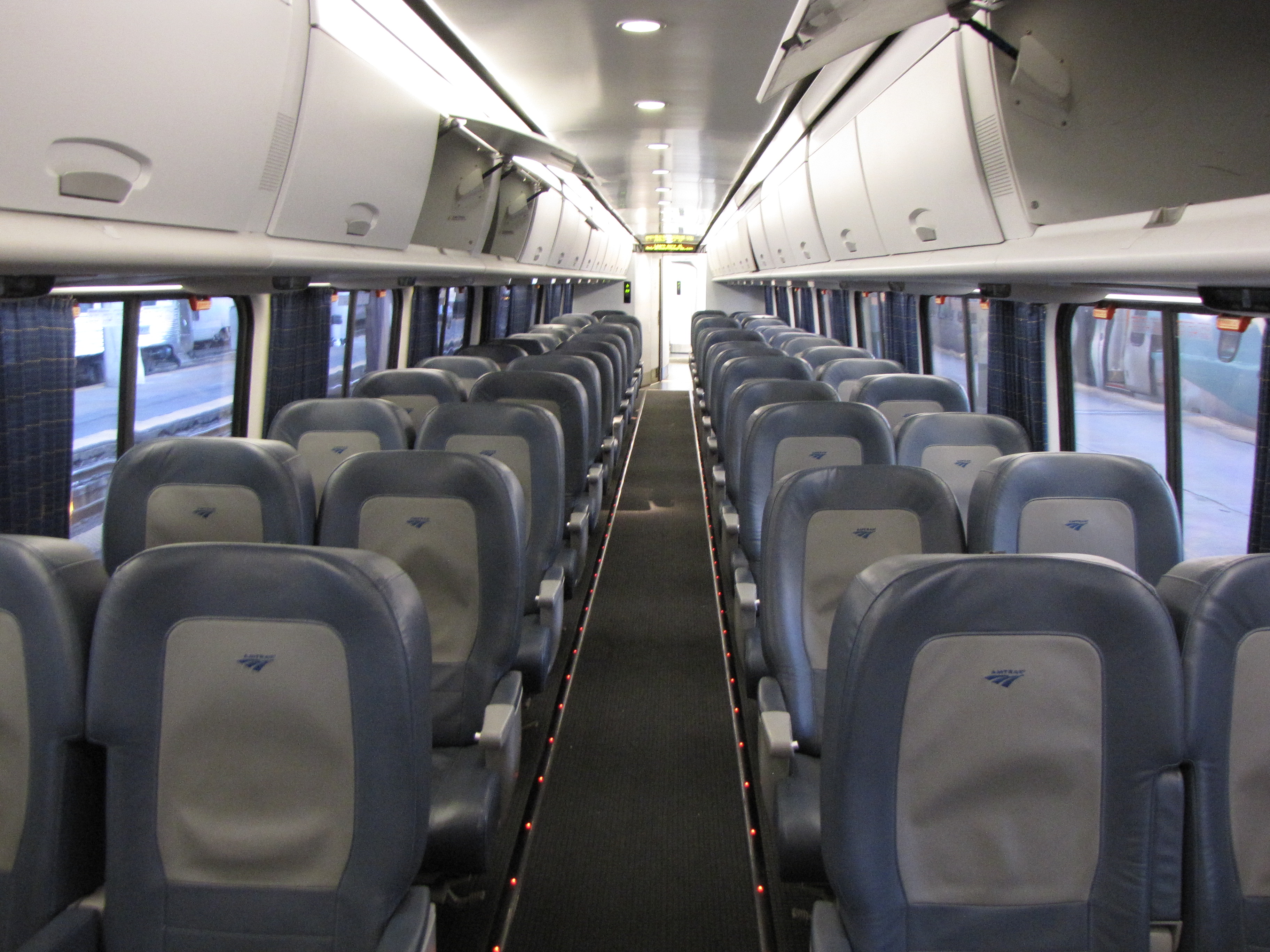 Acela_Express_business_class_interior_with_overhead_bins_open.jpg