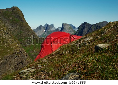 stock-photo-red-tent-set-up-on-a-steep-hillside-on-moskenesoya-lofoten-norway-56672998.jpg